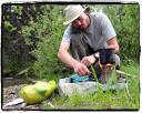 Sam cooking by a creek