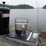 A pot of coffee, a book and a lake