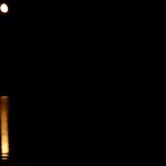 "The moon rose glittering over the darkened sea"
