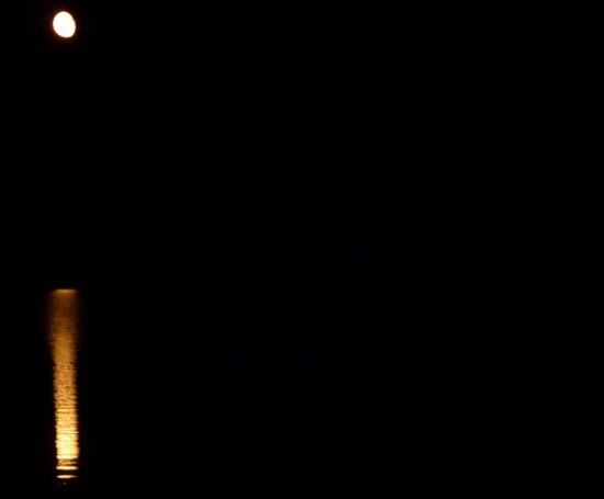"The moon rose glittering over the darkened sea"